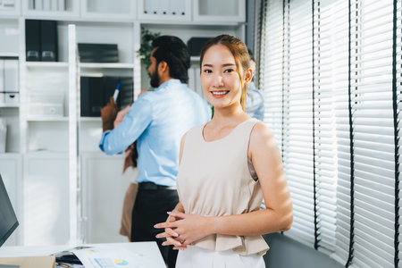 Portrait of confident businesswoman looking camera, Business team meeting and brainstorming at company, Employees using laptop working with business projectの写真素材