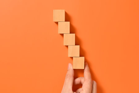 Hand with wooden cubes mock up on abstract background, Copy space, Wooden blocks with copy space for text or symbols, Background with copy spaceの写真素材