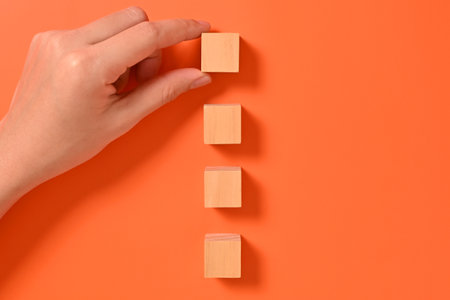 Hand with wooden cubes mock up on abstract background, Copy space, Wooden blocks with copy space for...