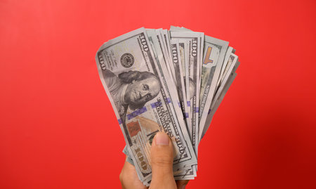 Hundred dollar bills on red background, Banknotes for money saving, Cash money dollars, Business...