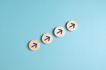 Arrow up icon on wooden blocks, Business growth success process, Business achievement goal and target, Planning and development for corporationの写真素材