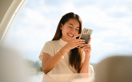 A woman is using a smart phone for various daily activities. The photo is of high quality.