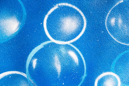 Urban bubbles painted on blue wallの写真素材