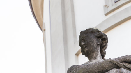 dirty statue covered with mossの写真素材