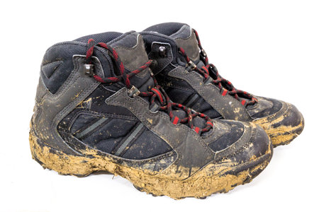 Close-up of muddy shoes after a hike on the mountain.の写真素材