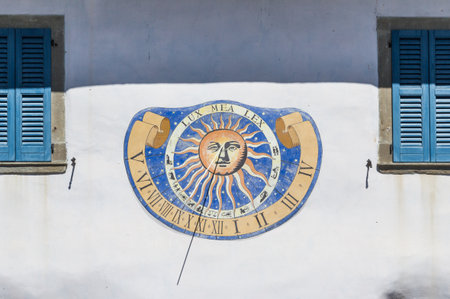 Sundial clock on old house wall in Italy - Riva di Solto -の写真素材