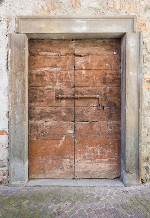 Old closed wooden door with rusty lockの写真素材