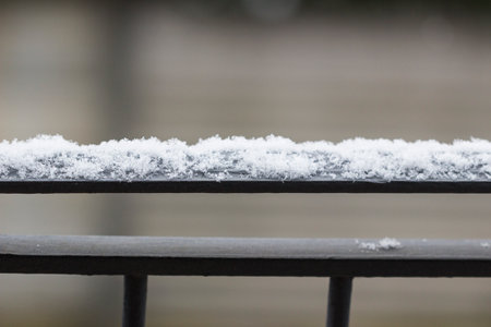 first snowflakes on the railingの写真素材