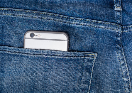 smartphone in jeans back pocket