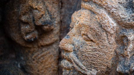Face carving in stone Sculpture at  biggest Buddhist temple Borobudur temple in Indonesiaの写真素材