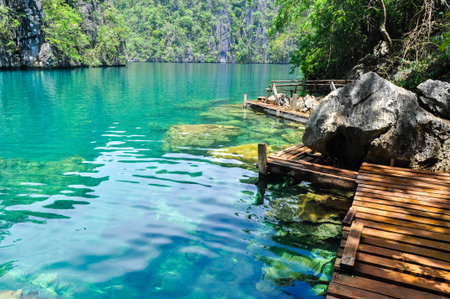 Very Clean and Clear lagoon lake Water next to a wooden path near Coron, Palawan, Philippinesの写真素材