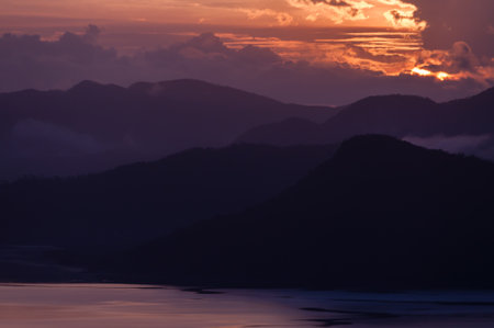 Silhouette of Mountains Above the Water under purple cloudscape clouds  at sunset near Coron, Palawan, Philippinesの写真素材