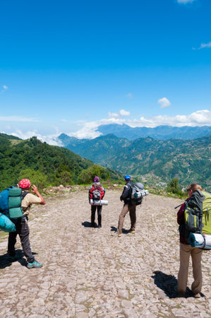 Group of people with backpacks taking a picture of The Mountains and hiking the mountain Tajamulco on pathway near the city of Quetzaltenango Guatemalaの写真素材
