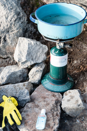 Boiling Water with camping stove amidst big Rocks and stones in The Mountain Tajamulco in Guatemalaの写真素材