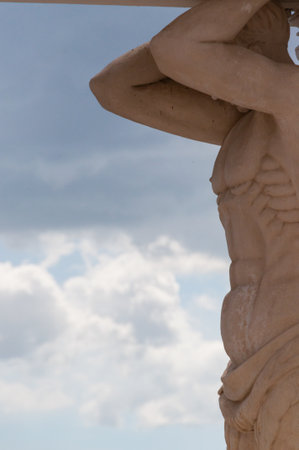 Close-up of A Musculared stone Sculpture in front of cloudscape on top of cathedral of Leon in Nicaraguaの写真素材