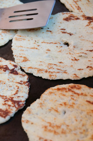 own beige Tortillas on stovetop Being Cooked on the Pan in the streets of Matagalpa in Nicaragua