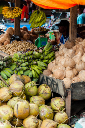 Vendor Selling Coconuts and Green Bananas at local market in Tana Toraja, Sulawesi, Indonesiaの写真素材
