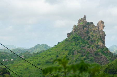 Green mountain top on cape verde island over mist cloudsの写真素材