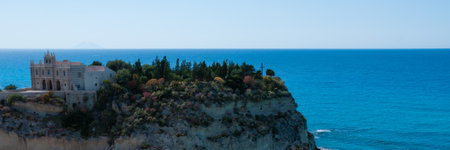Church on top of rock hill at the sand beach coast of Tropea in calabria, italyの写真素材