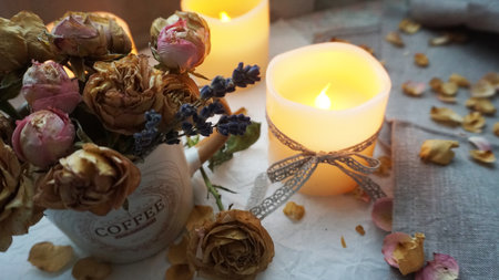 Vintage flowers and burning candlesの写真素材