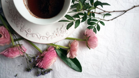 Vintage cup of coffee and pink ranunculusの写真素材