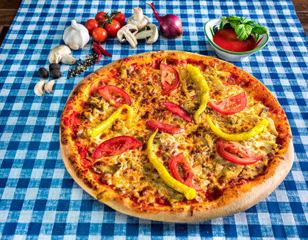 Cheese pizza with tomato and hot green pepperの写真素材