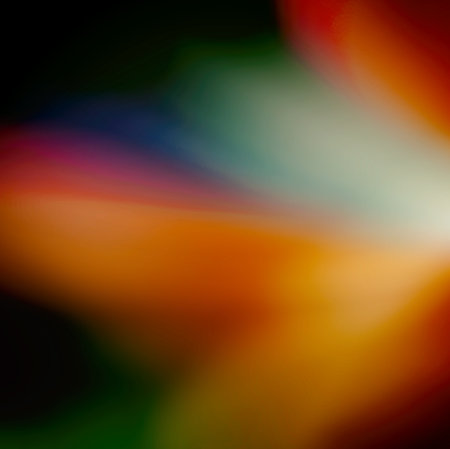 colorful abstract background with blurred light leaks or bokeh lights in orange blue purple pink yellow and green on black backgroundの写真素材