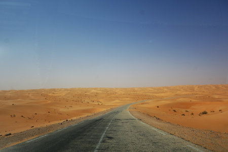 Endless road crossing endless sandsの写真素材
