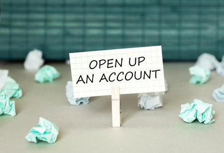white paper with text OPEN UP AN ACCOUNT on the green background with a lot of another paperの写真素材
