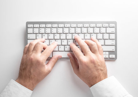 male hands on a white keyboard on a white background. Business concept.