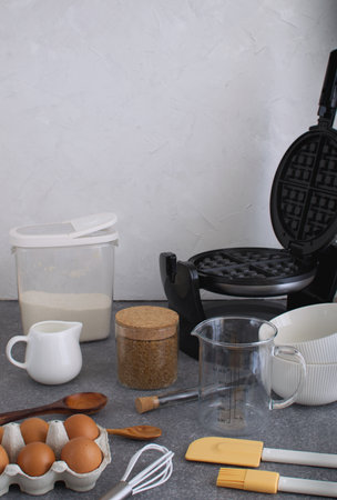Cooking background of ingredients and kitchen utensils to prepare homemade belgian wafflesの写真素材