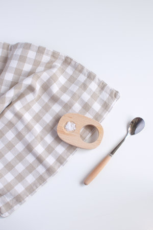 Served table for breakfast Egg cup with salt spoon and checkered napkin White background Top view Minimalism Copy spaceの写真素材