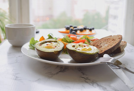 Close up Selective focus of baked avocado with quail eggs Healthy eating concept Breakfast Brunch...