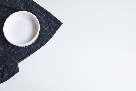 White baking mold and checkered black napkin Minimal Picture White Background Kitchen Supplement...
