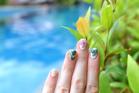 Trendy summer manicure flamingoes palm leaves swimming pool Vacationの写真素材