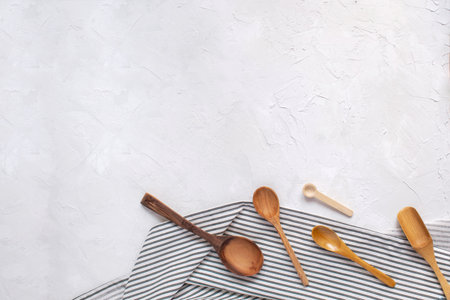 Cooking food minimal concept - wooden spoons on Crumpled Striped Napkin. Top view, Flat lay, Copy space.の写真素材