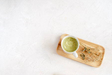 Healthy coffee alternative - matcha latte in white  on wooden tray, top view,  , white background, minimal picture.の写真素材