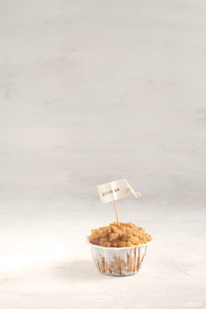 Making choise concept, diet, weight loss, overeating, muffin with pick me topper, white background,...