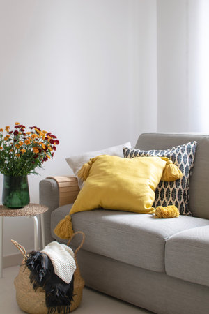 Scandinavian autumn inspired home decor - cozy Living room, Sofa Cushion, traw basket, mums flowers bouquet, hygge style, copy spaceの写真素材