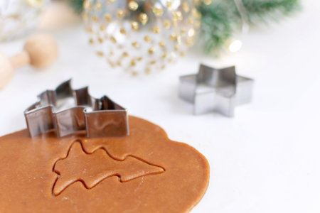 Christmas cooking background - selective focus of homemade gingerbread cookies dough, christmas tree...