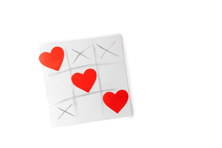 Valentine day concept, greetings card - tic tac toe drawn game with hearts isolated on white backgroundの写真素材