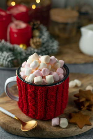 Winter drink - hot cocoa with marshmallows, mug in red handmade sweaterの写真素材
