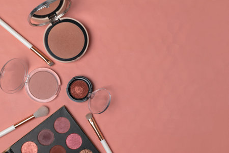 Makeup products, beauty, blogger, social media flat lay - powder, eyeshadows, makeup brushes on trendy living coral background, copy spaceの写真素材