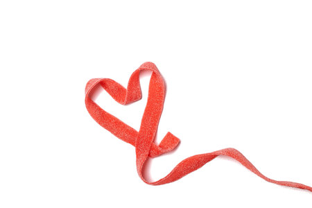 Valentines Womens mothers day concept 8 March - heart made of sour candy roll, red ribbon, isolated, white background, copy spaceの写真素材