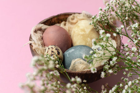Easter celebration card - selective focus of natural coloured easter eggs with curcuma, beetroot,...