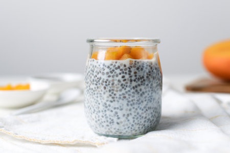 Chia pudding in glass jar with almond milk and mango on white background - healthy superfood vegan, dairy free breakfastの写真素材