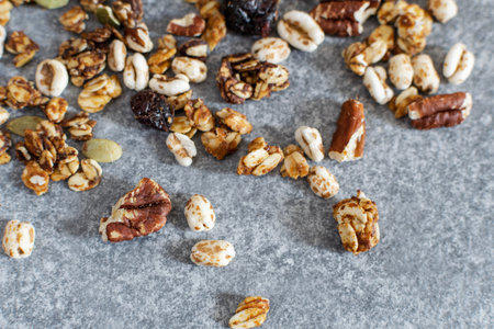 Organic homemade granola with pecan nuts on gray table, top view, copy spaceの写真素材