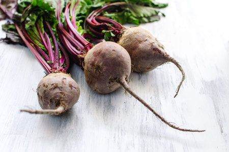 Fresh beetroot on rustic wooden background - vegetable summer harvest