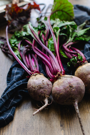 Fresh beetroot on rustic wooden background - vegetable summer harvest