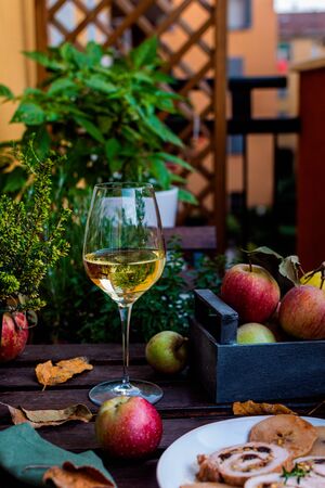 Fall table arrangement, meat roll filled with pistachios and prunes, white wine glass on rustic wooden table, thanksgivingの写真素材
